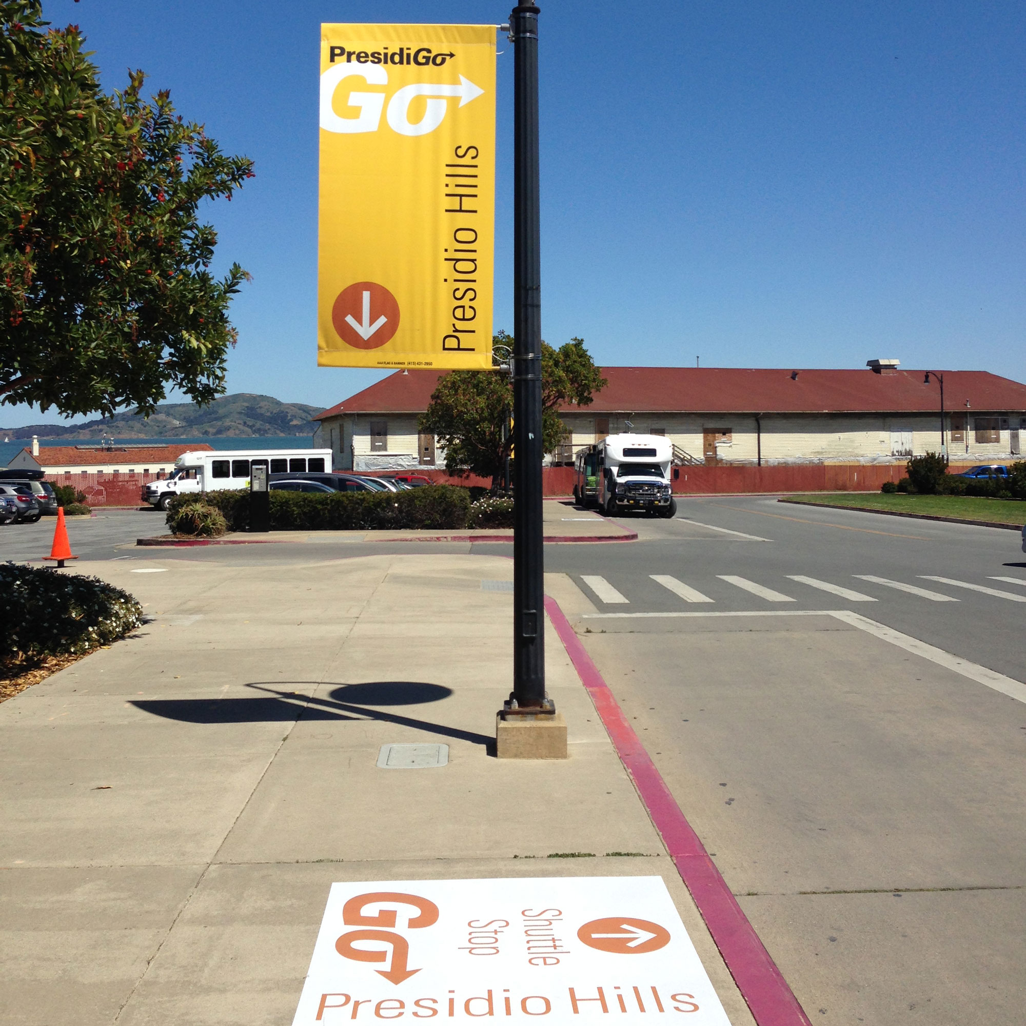 Exterior shuttle stop banner and sidewalk graphic.