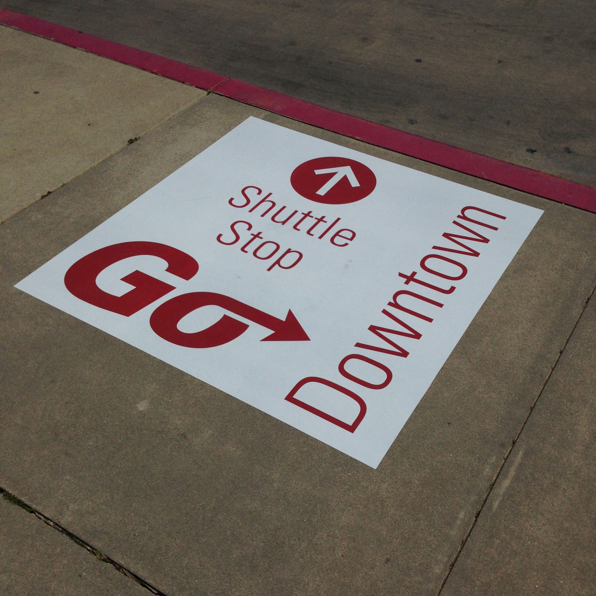 Sidewalk shuttle stop graphic.